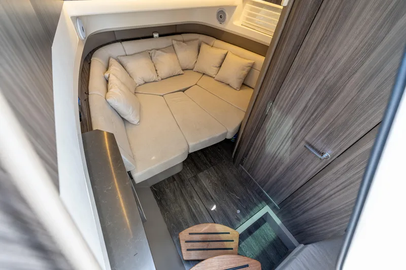 Slide: The Image of 2019 Sea Ray SLX 400 Outboard cabin interior with cozy seating and modern design. - 48