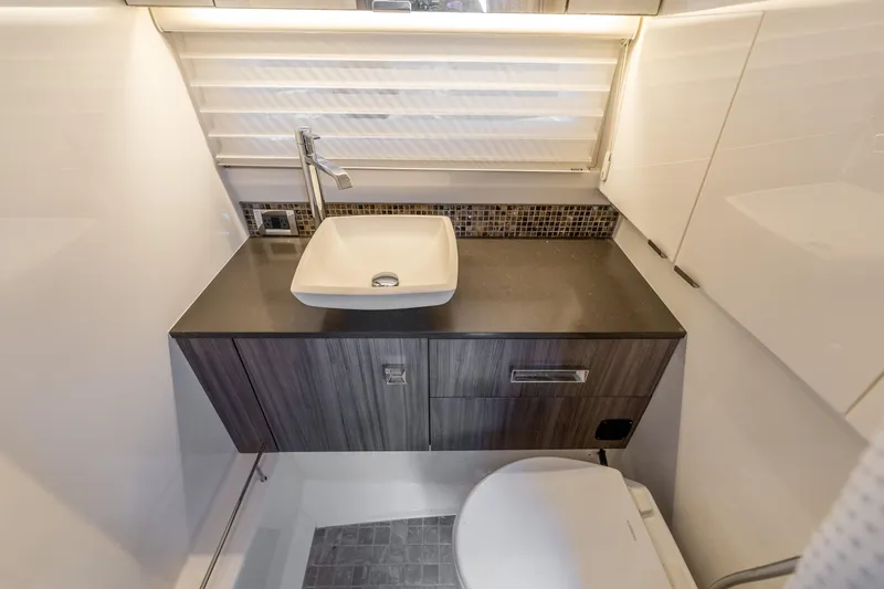 Slide: The Image of Luxurious bathroom in 2019 Sea Ray SLX 400 Outboard with modern sink and toilet. - 53