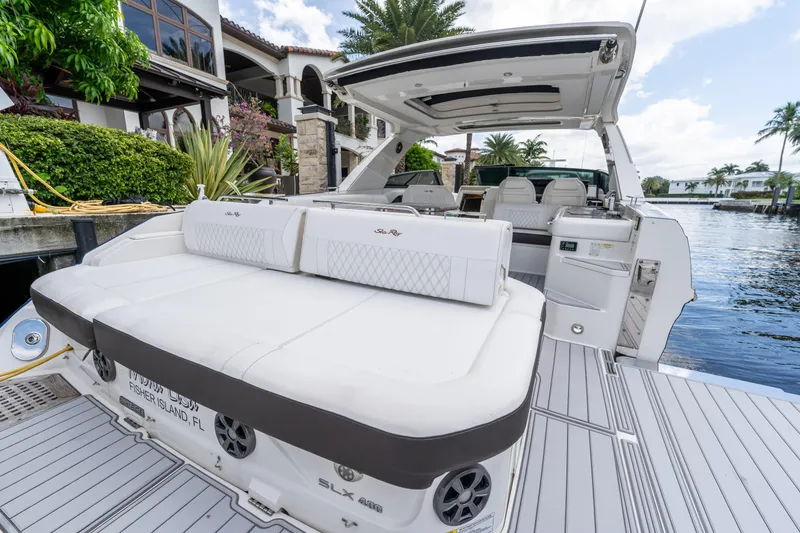 Slide: The Image of 2019 Sea Ray SLX 400 Outboard luxury boat docked by waterfront villa. - 62