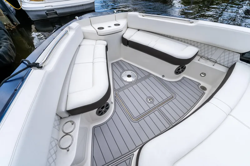 Slide: The Image of 2019 Sea Ray SLX 400 Outboard boat interior with white seating and gray flooring. - 65