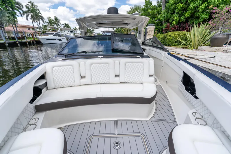 Slide: The Image of 2019 Sea Ray SLX 400 Outboard boat with luxurious seating, docked by a scenic waterfront. - 66
