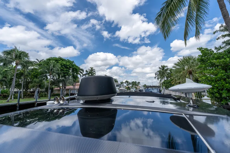 Slide: The Image of 2019 Sea Ray SLX 400 Outboard on a sunny day with palm trees and blue sky. - 67