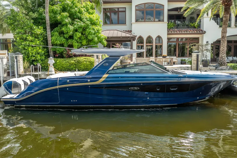 Slide: The Image of 2019 Sea Ray SLX 400 Outboard boat docked by a luxurious waterfront home. - 7