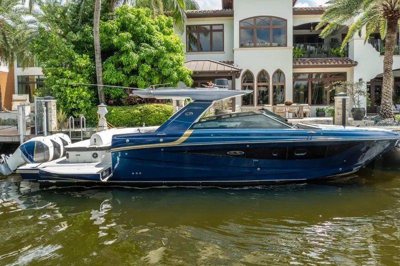 Slide: The Image of 2019 Sea Ray SLX 400 Outboard boat docked by a luxurious waterfront home. - 8