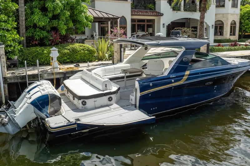 Slide: The Image of 2019 Sea Ray SLX 400 Outboard luxury boat docked by waterfront home. - 9