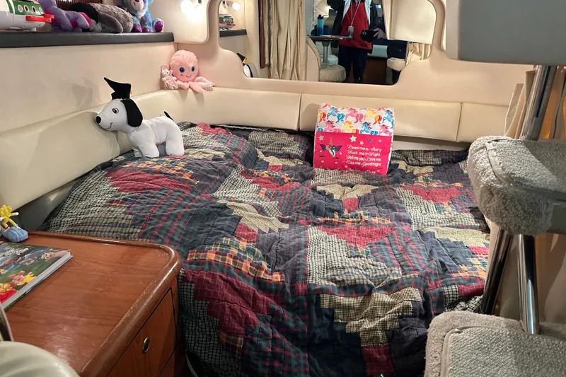 Slide: The Image of Cozy cabin interior of 1999 Sea Ray 340 Sundancer with plush toys and colorful bedding. - 15