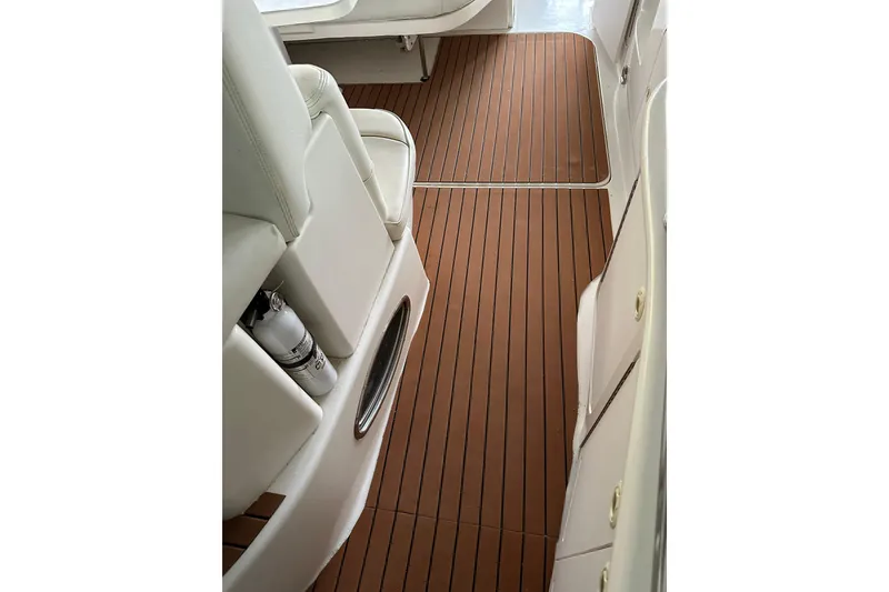 Slide: The Image of 1999 Sea Ray 340 Sundancer interior with teak flooring and white seating. - 21