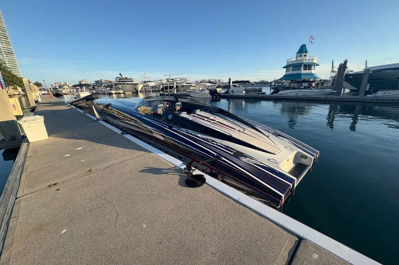 Slide: The Image of 2018 Mystic Powerboats C4400 docked at marina under clear blue sky. - 11