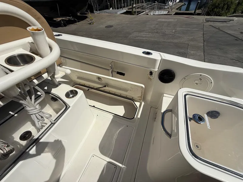 Slide: The Image of 2023 Bayliner Trophy T24CC boat interior with storage compartment and seating. - 17