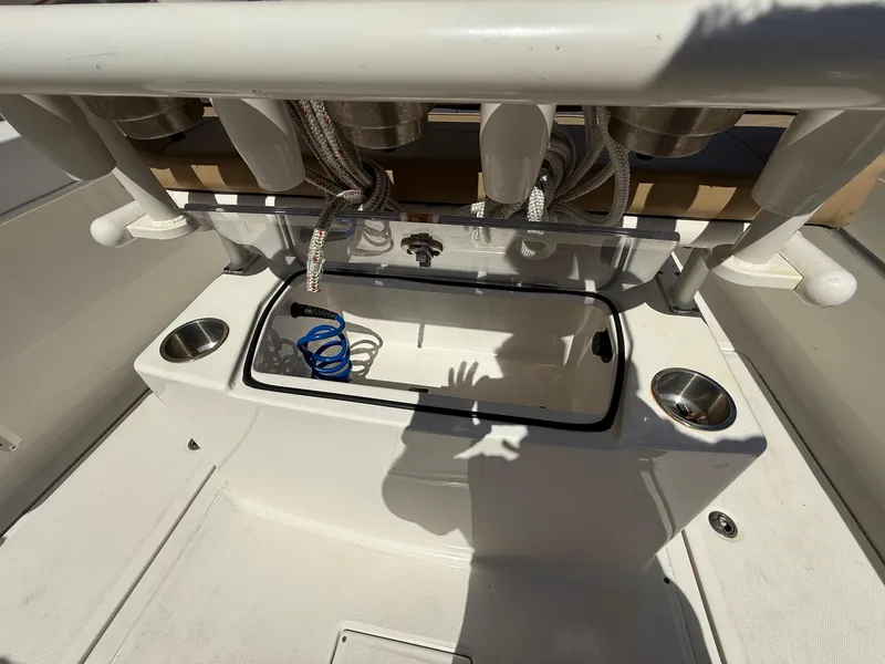 Slide: The Image of 2023 Bayliner Trophy T24CC boat interior with storage compartments and cup holders. - 18