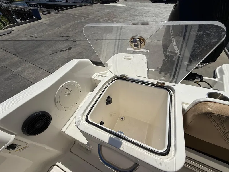 Slide: The Image of 2023 Bayliner Trophy T24CC boat deck with storage compartment and cup holders. - 19