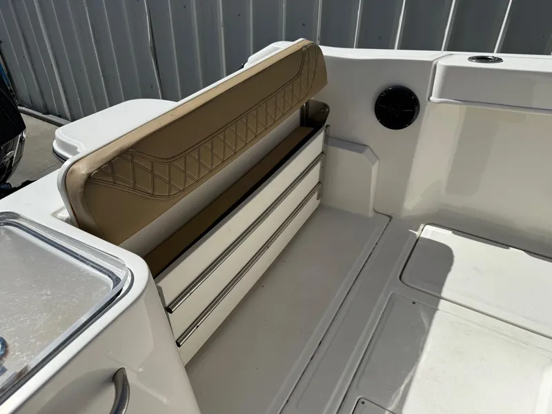 Slide: The Image of 2023 Bayliner Trophy T24CC boat with tan seating and white interior. - 21
