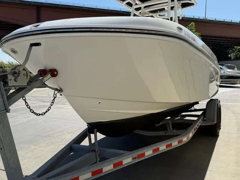 Slide: The Image of 2023 Bayliner Trophy T24CC boat on a trailer at a marina. - 4