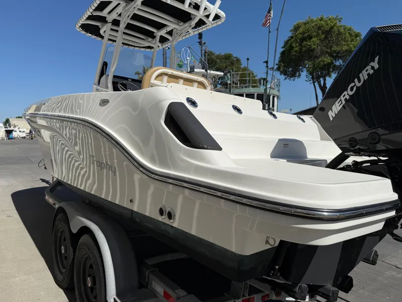 Slide: The Image of 2023 Bayliner Trophy T24CC boat on trailer under bridge. - 5