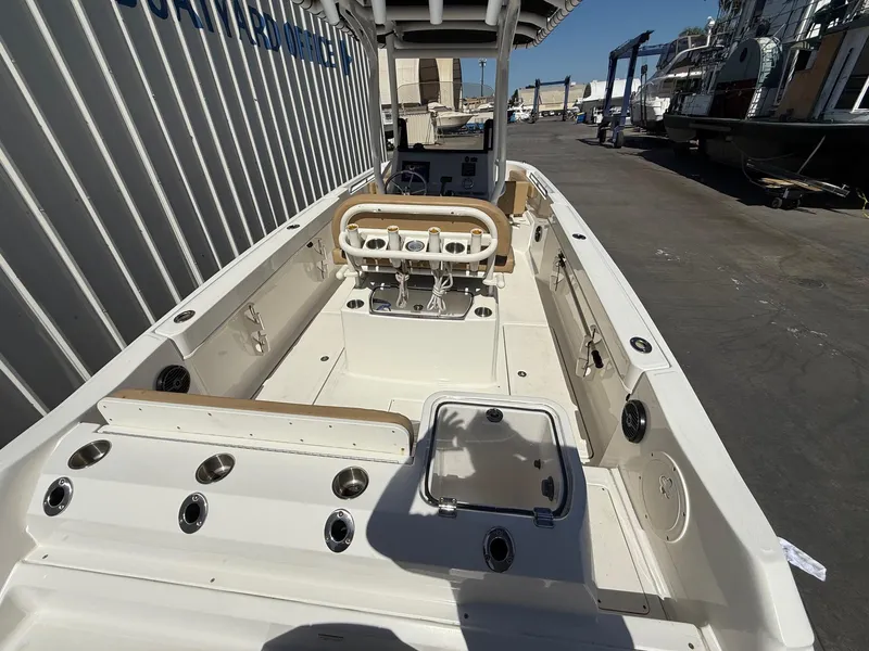 Slide: The Image of 2023 Bayliner Trophy T24CC boat on trailer, parked outside sales office. - 8