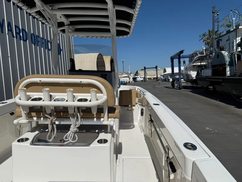 Slide: The Image of 2023 Bayliner Trophy T24CC boat interior with seating and fishing rod holders. - 9