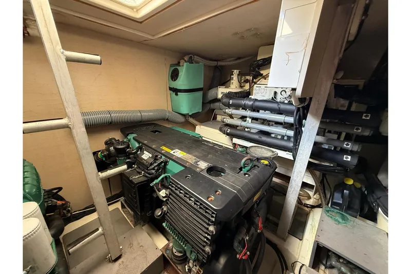 Slide: The Image of Engine room of a 2013 Prestige 50 Flybridge yacht, showcasing mechanical components. - 15