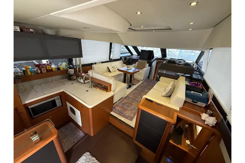 Slide: The Image of Luxurious interior of 2013 Prestige 50 Flybridge yacht with modern kitchen and seating area. - 18