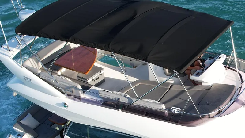 Slide: The Image of Flybridge of 2014 Prestige 50 yacht with black canopy over seating area. - 21