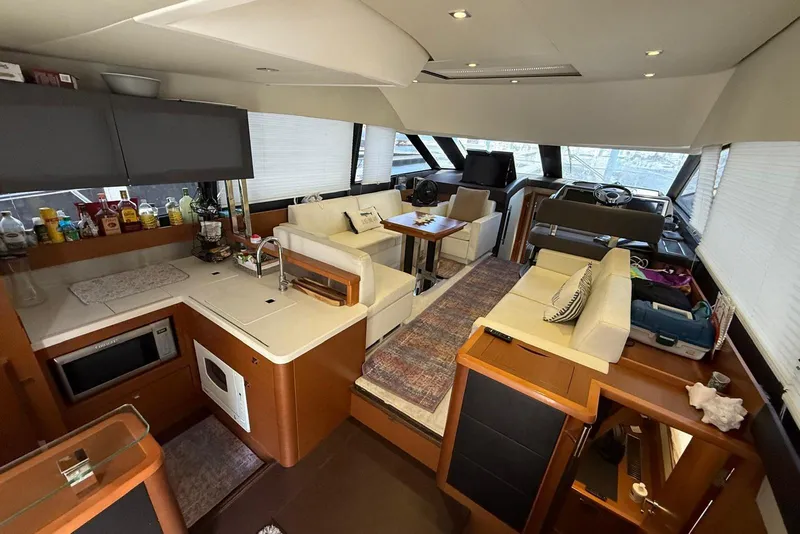 Slide: The Image of Luxurious interior of 2013 Prestige 50 Flybridge yacht with modern kitchen and seating area. - 3