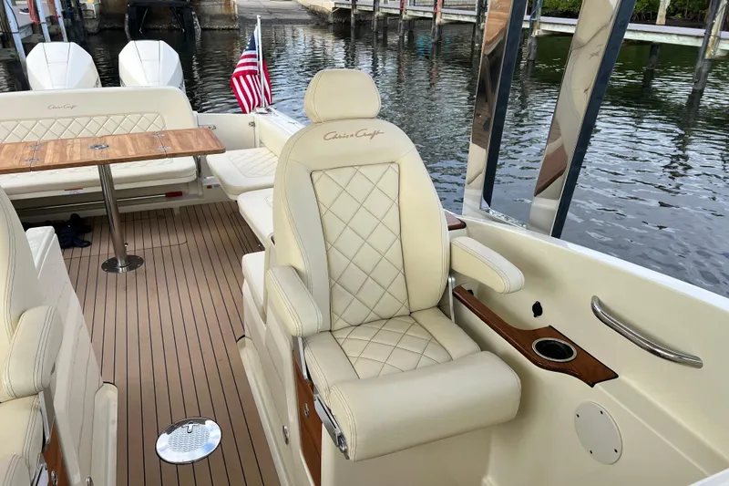 Slide: The Image of 2023 Chris-Craft Calypso 30 interior with luxurious seating and elegant wood accents. - 13