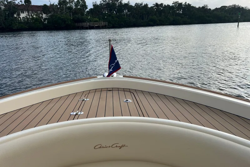 Slide: The Image of 2023 Chris-Craft Calypso 30 boat deck with water view and flag. - 19