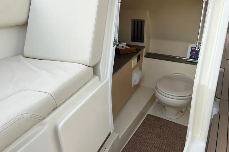 Slide: The Image of 2023 Chris-Craft Calypso 30 boat interior with toilet and seating area. - 20