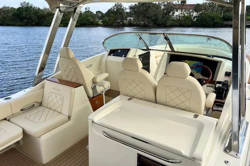 Slide: The Image of 2023 Chris-Craft Calypso 30 boat interior with luxurious seating and modern dashboard. - 8