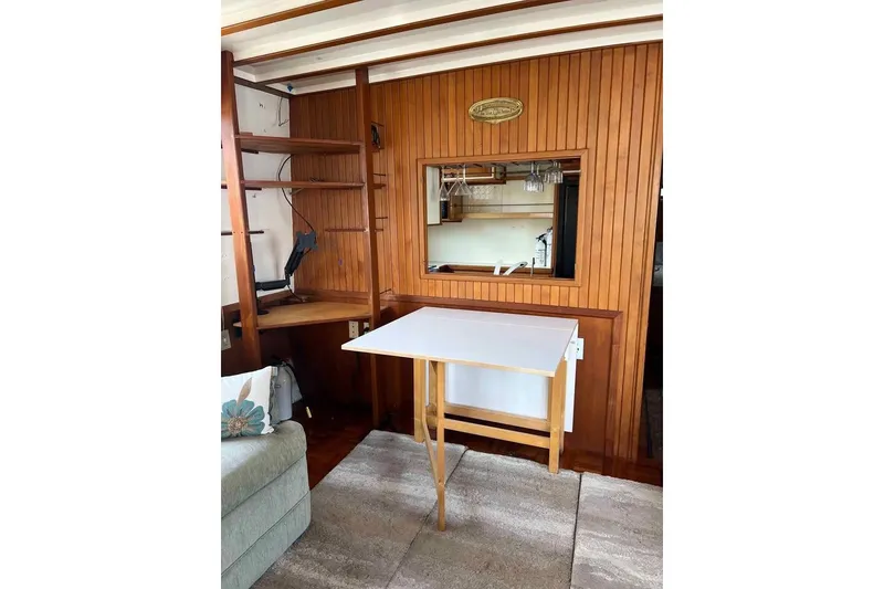 Slide: The Image of 1987 Kadey-Krogen Manatee 36 interior with wooden paneling and foldable table. - 2