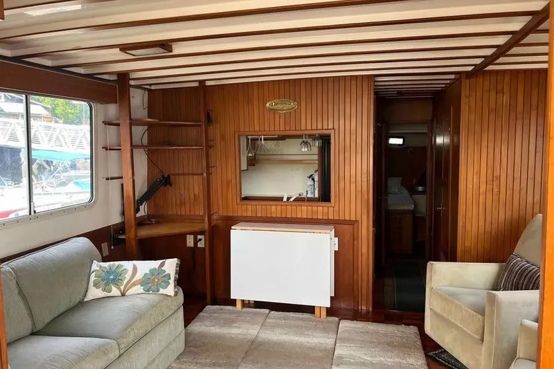 Slide: The Image of Interior of 1987 Kadey-Krogen Manatee 36 with wood paneling and cozy seating area. - 3