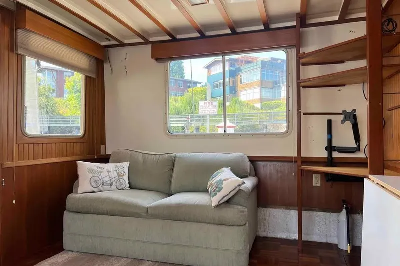 Slide: The Image of Interior of 1987 Kadey-Krogen Manatee 36 with sofa, windows, and wooden shelves. - 4