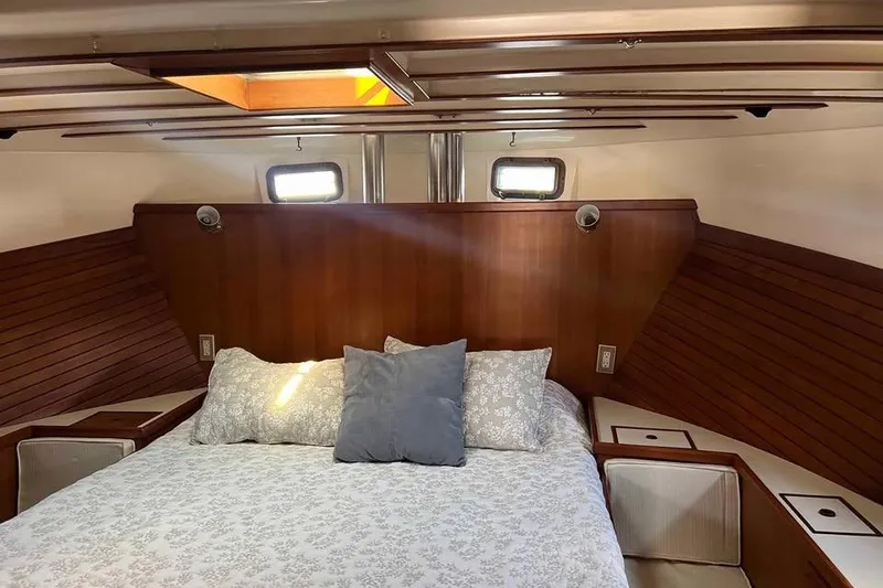 Slide: The Image of Cozy cabin interior of 1987 Kadey-Krogen Manatee 36 with wooden accents and bedding. - 5