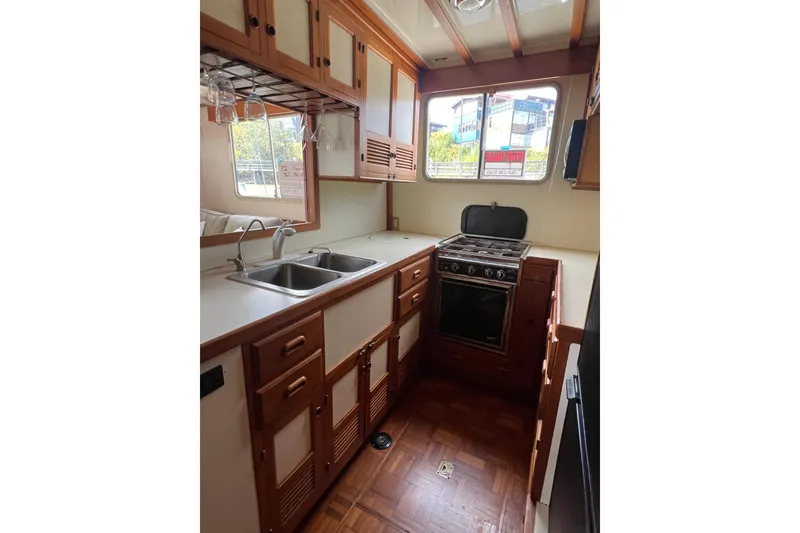 Slide: The Image of 1987 Kadey-Krogen Manatee 36 yacht kitchen with wood cabinetry and modern appliances. - 8
