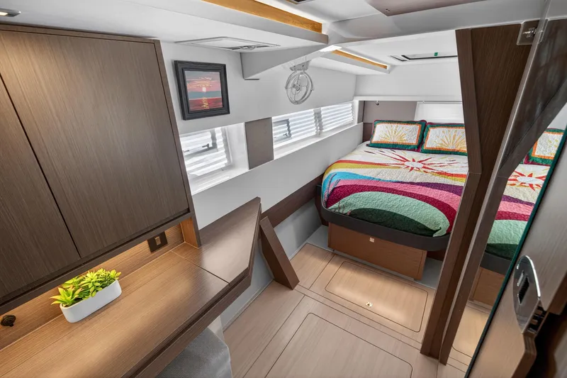 Slide: The Image of Luxurious 2024 Leopard 45 yacht cabin with colorful bedding and modern wood furnishings. - 101