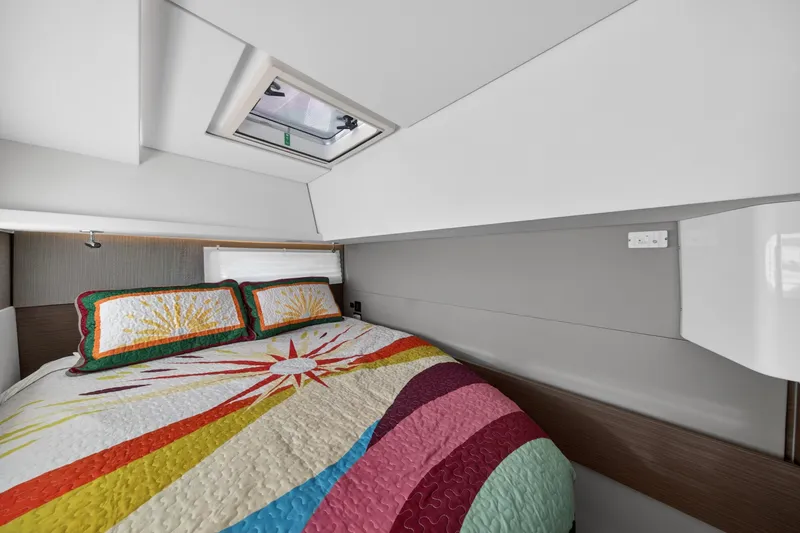 Slide: The Image of Luxurious cabin interior of 2024 Leopard 45 yacht with colorful bedding and skylight. - 105
