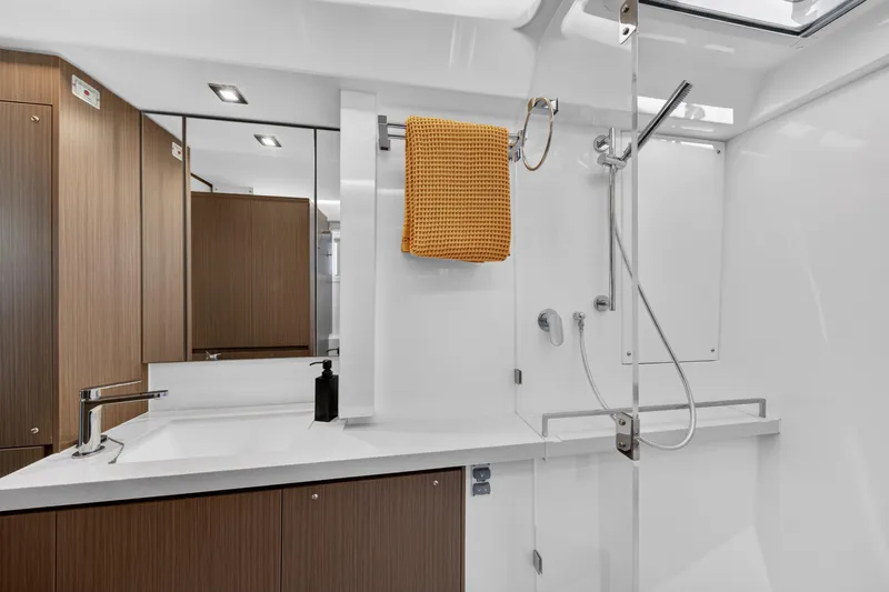 Slide: The Image of Modern bathroom interior on 2024 Leopard 45 yacht, featuring sleek fixtures and wood accents. - 112