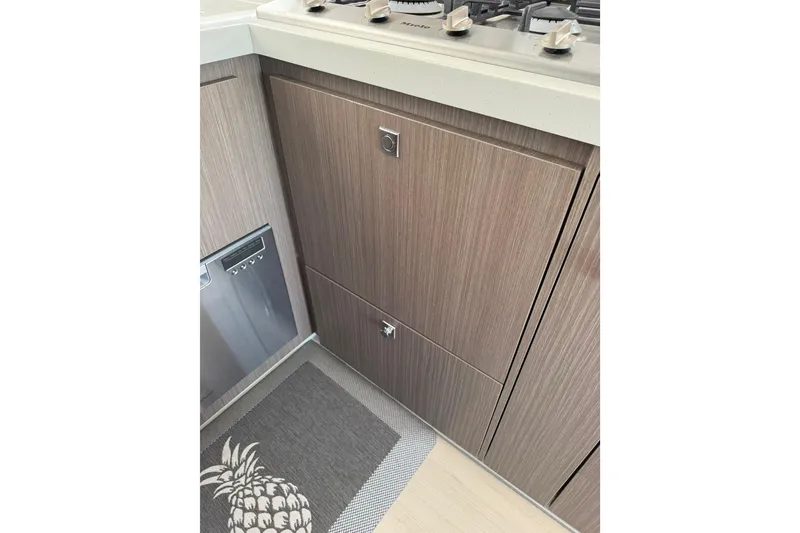Slide: The Image of Modern kitchen interior in 2024 Leopard 45 yacht, featuring wood cabinetry and stainless steel appliances. - 13
