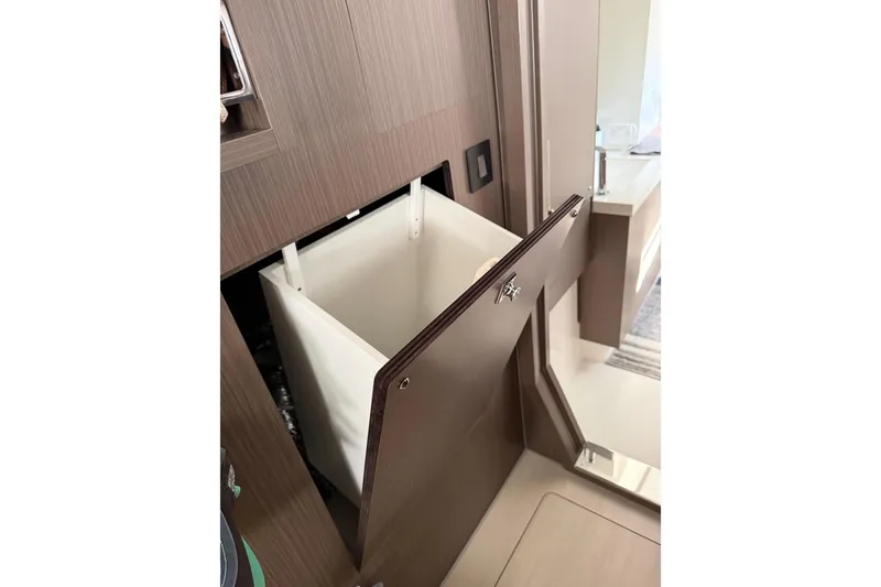 Slide: The Image of 2024 Leopard 45 yacht interior with built-in laundry hamper. - 14