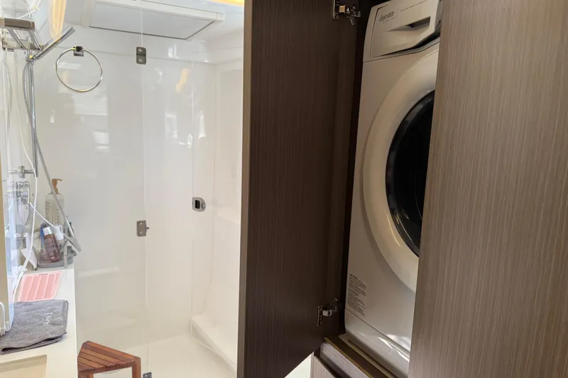 Slide: The Image of 2024 Leopard 45 yacht bathroom with shower and built-in washer. - 15