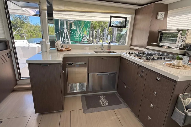 Slide: The Image of Modern kitchen interior on 2024 Leopard 45 yacht, featuring sleek cabinetry and appliances. - 18