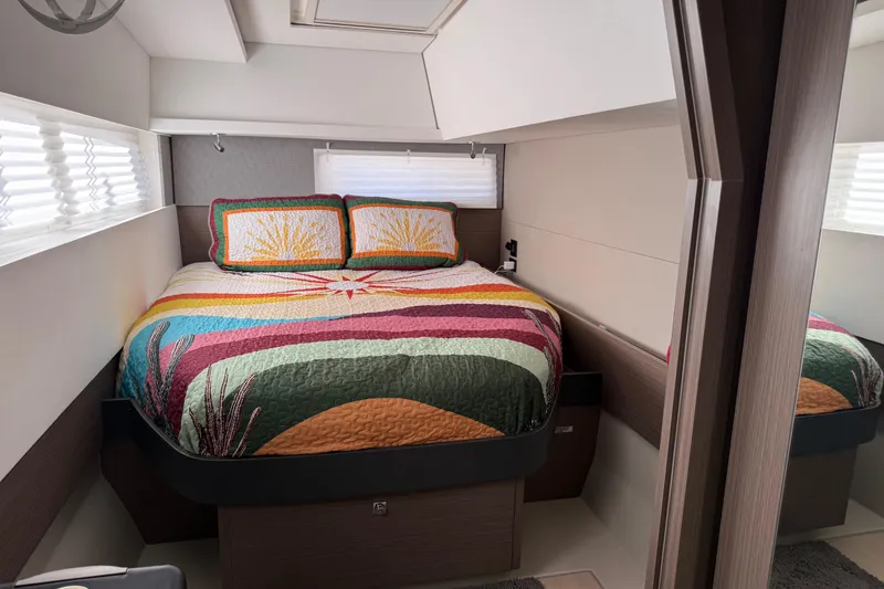 Slide: The Image of Modern bedroom interior in 2024 Leopard 45 yacht with colorful bedding and sleek design. - 32