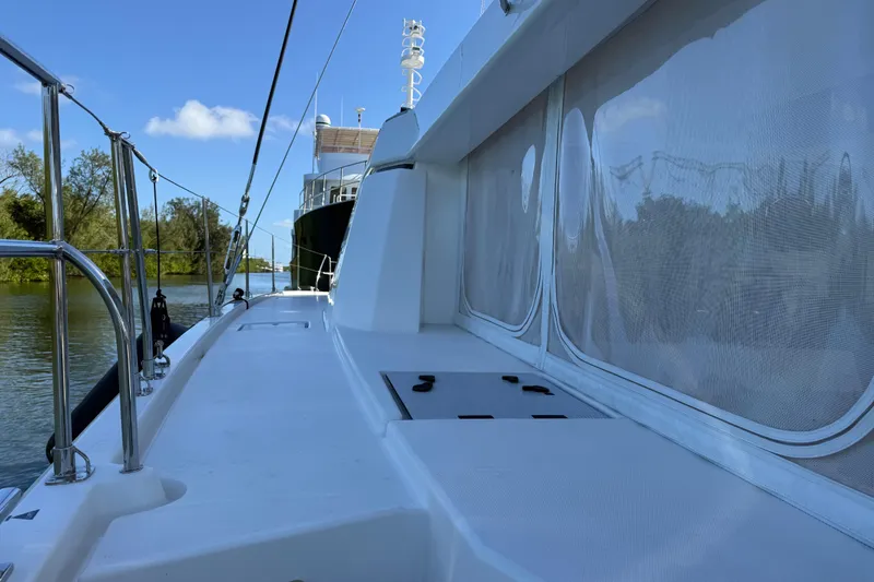 Slide: The Image of 2024 Leopard 45 yacht deck with railing, cruising on a calm river. - 5