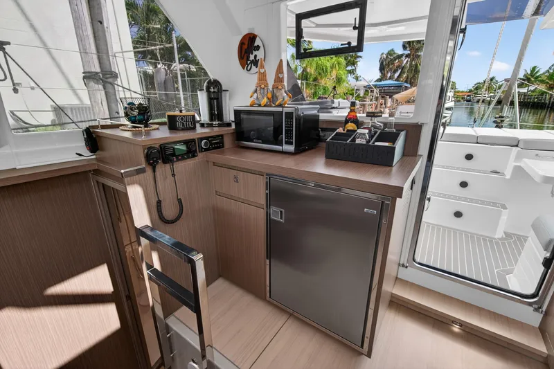 Slide: The Image of Modern kitchen area on a 2024 Leopard 45 yacht, featuring appliances and outdoor view. - 68