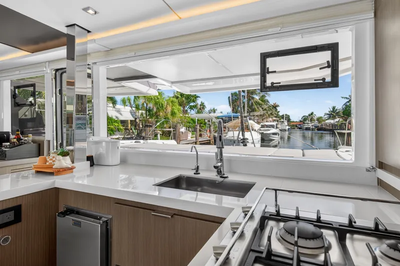 Slide: The Image of Modern kitchen interior on 2024 Leopard 45 yacht, featuring sleek design and marina view. - 75