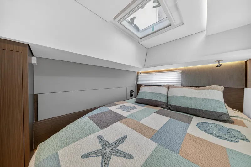 Slide: The Image of Luxurious bedroom interior of 2024 Leopard 45 yacht with skylight and quilted bedding. - 85