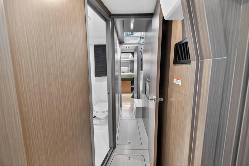 Slide: The Image of Modern interior of 2024 Leopard 45 yacht, featuring hallway, bathroom, and bedroom. - 86