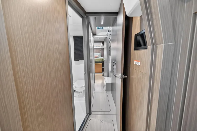 Slide: The Image of Interior hallway of 2024 Leopard 45 yacht, featuring modern wood paneling and compact design. - 87