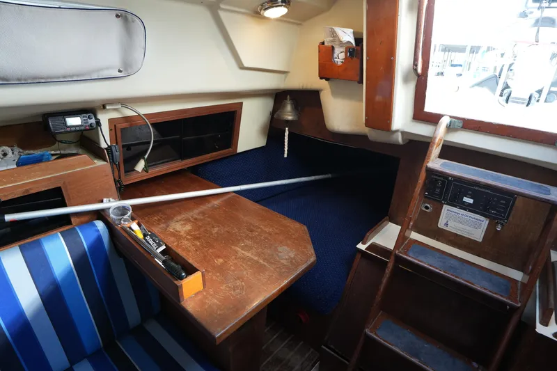 Slide: The Image of Interior of a 1985 Pearson 303 sailboat with wooden furnishings and nautical equipment. - 22