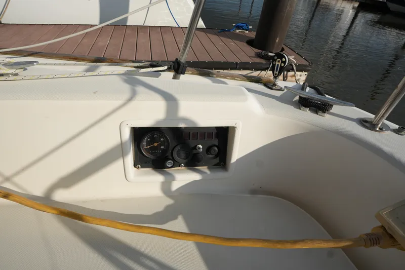 Slide: The Image of Cockpit of 1985 Pearson 303 sailboat with instrument panel and marina view. - 9