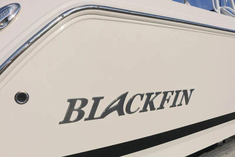 Slide: The Image of 2021 Blackfin 252 CC boat side view with logo and chrome detailing. - 16
